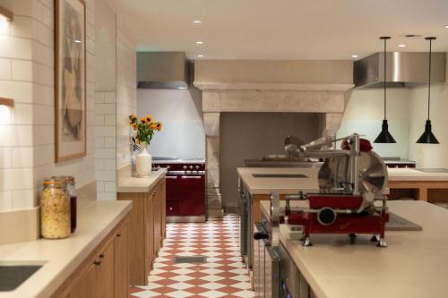a large kitchen with a checkered floor at Bellevigne Bourgogne in Chambolle-Musigny