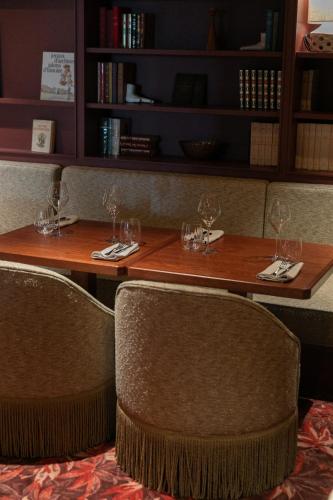 a wooden table with wine glasses on top of it at Bellevigne Bourgogne in Chambolle-Musigny