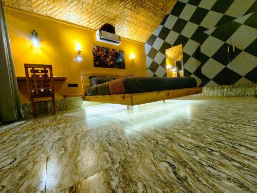 a living room with a bed and a checkerboard floor at Samyama Retreat in Cola