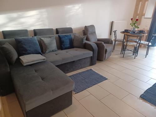 a living room with a couch and a table at Éva Apartmanház in Eger
