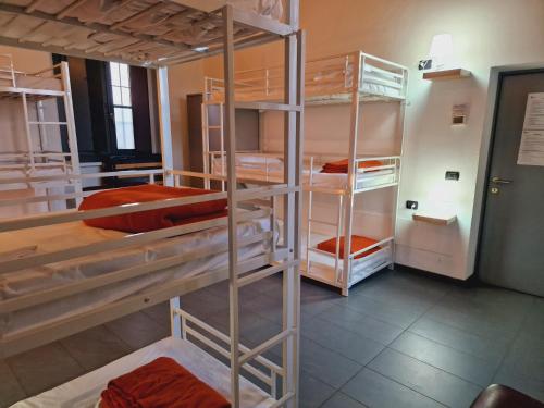 a room with three bunk beds in a room at B&B e Ostello, Parco di Monza, CASCINA COSTA ALTA in Monza
