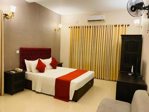 a hotel room with a bed and a couch at Forever City Hotel in Kiribathgoda