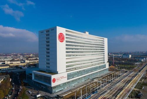 a large white building with a red logo on it at Bed and Breakfast Santa Elisa in Pero