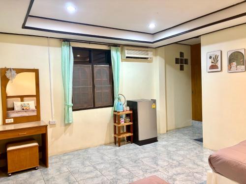 a room with a refrigerator and a table at Sea Sun Bungalow in Ko Lanta
