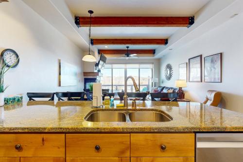 a kitchen with a sink and a living room at Newpark Townhomes 28 in Park City