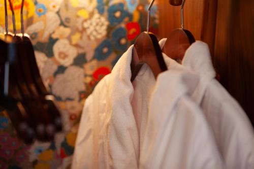 a row of white shirts hanging on a rack at The Flat Iron Hotel in Asheville