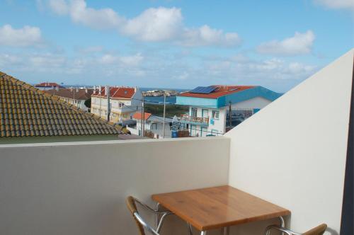 a table and chairs on a balcony with a view at Hotel Baleal Spot in Baleal