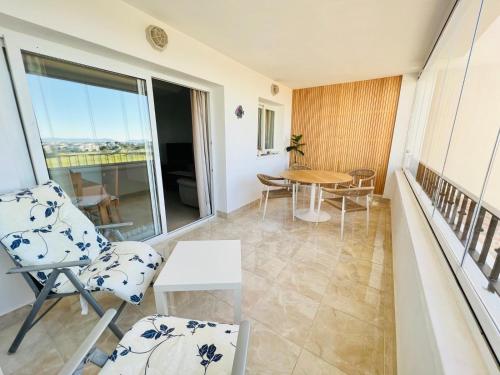 a room with a balcony with a table and chairs at Pedro’s Apartment in Sucina