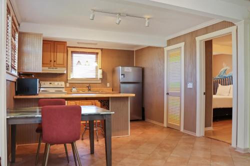 a kitchen with a table and chairs and a refrigerator at Off The Hook by Pristine Properties Vacation Rentals in Saint Joe Beach
