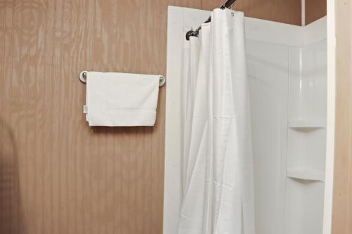 a bathroom with a white shower curtain and a towel at Off The Hook by Pristine Properties Vacation Rentals in Saint Joe Beach