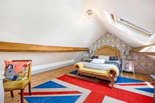 a bedroom with a bed and a red white and blue rug at Meagill Cottage Sleeps 4 with Hot Tub & Parking in Otley