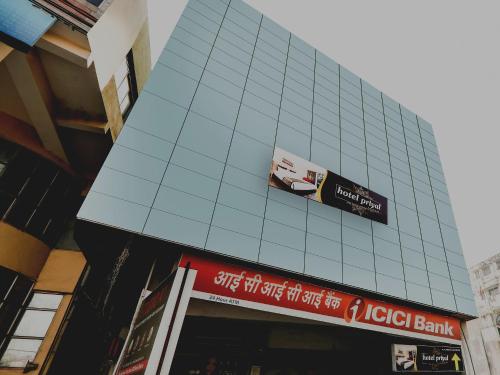 a building with a sign on the side of it at Hotel O Priyal in Chās
