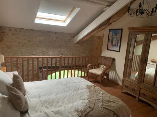 a bedroom with a bed and a balcony at La Ferme de Borie in Fumel