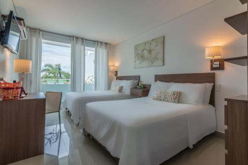 托卢Hotel Soleira的带窗户的酒店房间里有两张床