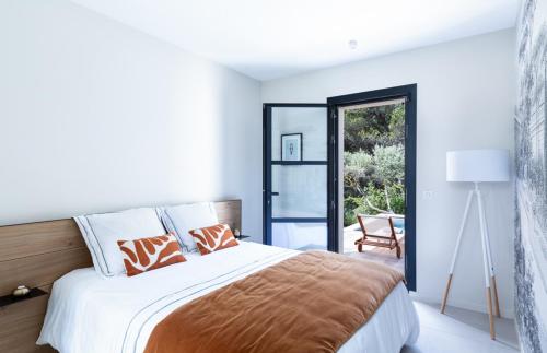 a bedroom with a large bed and a sliding glass door at Maison de Lauris in Lauris
