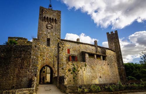 an old stone building with a clock tower at Tarrit de Bas in Castelnau-dʼAuzan