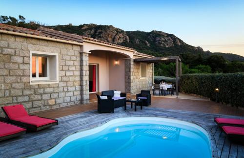 a villa with a swimming pool and a house at Villa Margaux in Figari