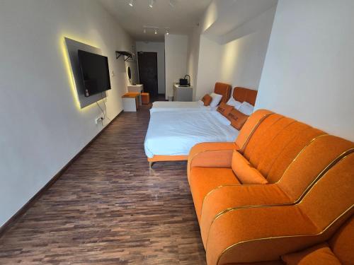 a living room with a couch and a bed at K Avenue Kota Kinabalu by Merveille - Sabah in Donggongon
