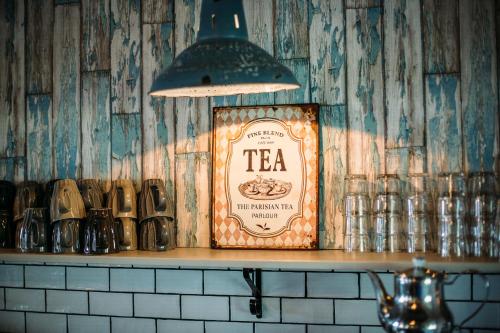 a sign on top of a shelf in a bar at Hotell Mossbylund in Abbekås