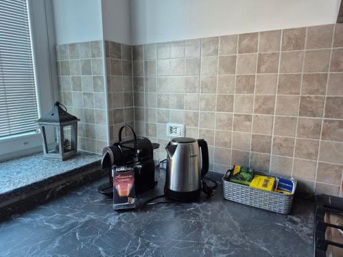 a coffee maker sitting on a counter in a kitchen at Le Mimose Holiday House di Como - Grandate in Grandate