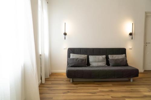 a couch sitting in a living room with two pillows at Casa TORRETTE in Ancona