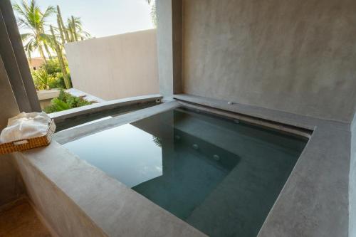 a swimming pool in the middle of a building at La Olita in Puerto Escondido