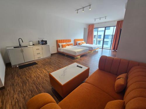 a living room with a couch and a table at K Avenue Kota Kinabalu by Merveille - Sabah in Donggongon