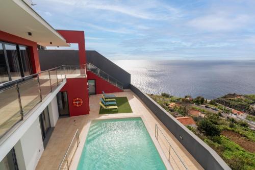 a balcony of a building with a swimming pool at Villa Rodrigues by Amazing Madeira in Ponta do Sol