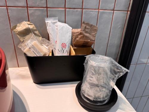 a black container filled with paper bags on a counter at Navona 68 in Rome