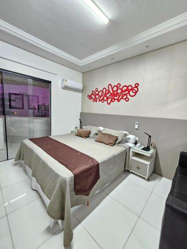 a bedroom with a bed and a red sign on the wall at Recife Mar Flats Hotel in Recife