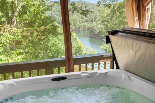 a bath tub with a view of a river at Lakeview Hideaway in Ellijay