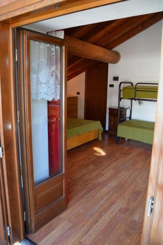 a room with a door and a bunk bed at Ca 'd Borla in Usseglio