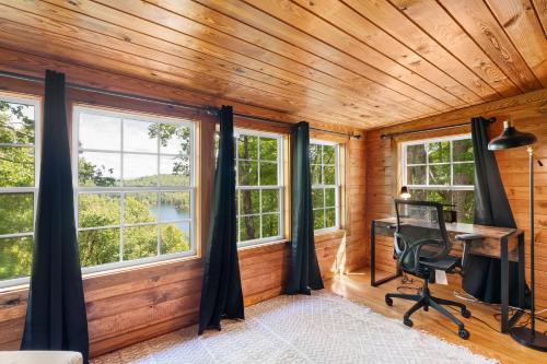 an office with windows in a wooden room with a desk at Lakeview Hideaway in Ellijay