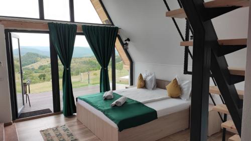 a bedroom with a bed and a large window at MOTEL PRISLOP in Haţeg