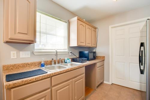 a kitchen with a sink and a microwave at Waterfront Lake Fork Getaway with Dock Access in Emory