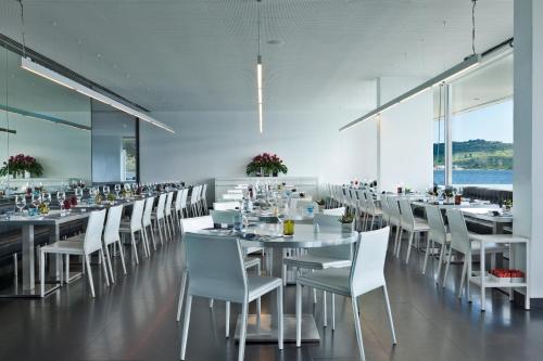 a dining room with white tables and white chairs at Altis Belem Hotel & Spa, a Member of Design Hotels in Lisbon