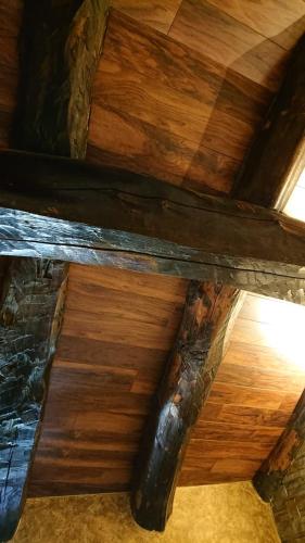 a wooden ceiling in a room with wooden floors at Casa Antón O Cebreiro in O Cebreiro