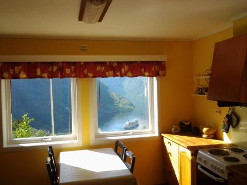 a kitchen with a window with a view of a lake at Lunheim in Geiranger in Geiranger