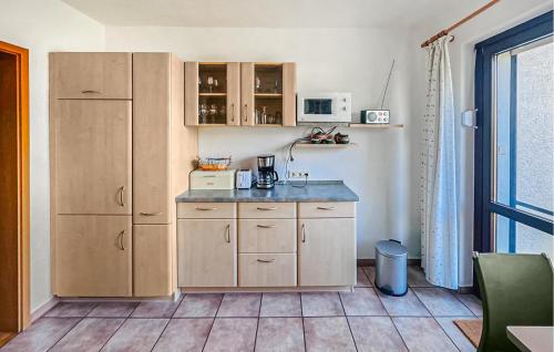 a kitchen with wooden cabinets and a counter top at Doppelhaushälfte Röbel-Müritz in Röbel