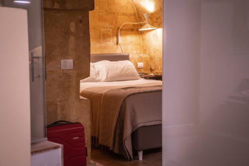 a small bedroom with a bed in a room at Suite San Biagio nei sassi in Matera