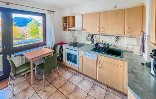 a kitchen with a table and a table and a window at Doppelhaushälfte Röbel-Müritz in Röbel