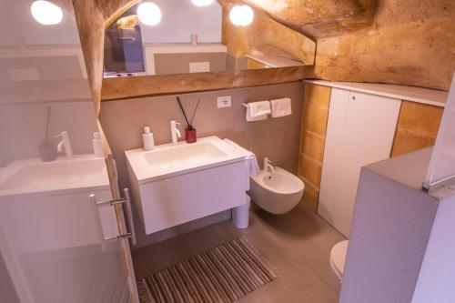 a bathroom with a sink and a toilet at Suite San Biagio nei sassi in Matera