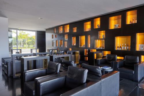 a waiting room with black leather chairs and tables at Altis Belem Hotel & Spa, a Member of Design Hotels in Lisbon