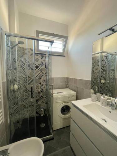 a bathroom with a shower and a toilet and a sink at Casa Flora in Finale Ligure
