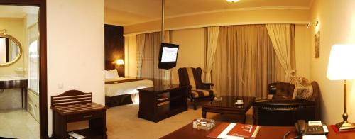 a hotel room with a living room with a hotel room at Hotel Monec in Ankara