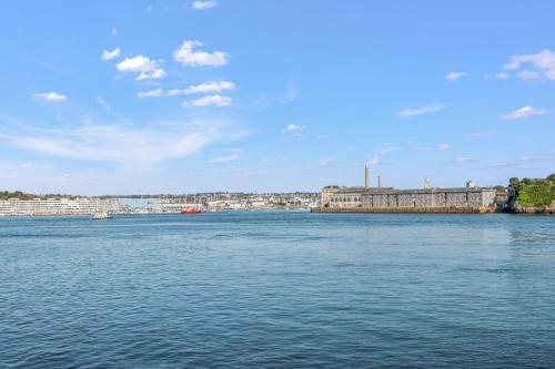 a large body of water with a city in the background at Seascape in Torpoint