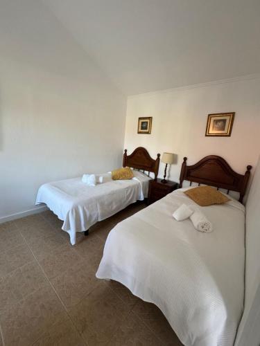 a hotel room with two beds with white sheets at Quinta do Cutato - Piscina Guest House in Santo Estêvão
