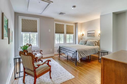 a bedroom with a bed and a bed and a table at Walk to Old Town Chic Alexandria Abode with Patio! in Alexandria