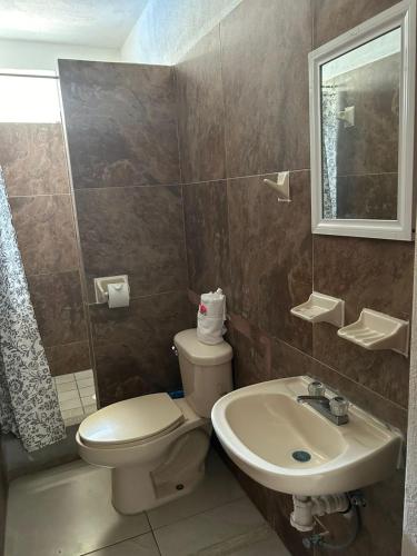 a bathroom with a toilet and a sink at Royal Pacífico Manzanillo in Manzanillo