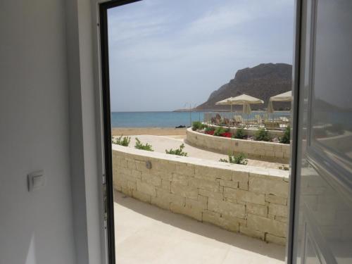 a view of the beach from a window at Blue Beach Villas Apartments in Stavros